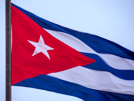 Cuba Flag Waving on flagpole, close up. Cuba flag flapping in the wind. Close-up of an Cuban flag flying in the wind against a background of clear sky. Cuba flag full frameの写真素材