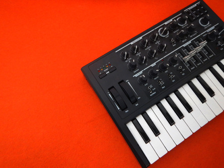 Electronic musical instrument or audio mixer or sound equalizer on a orange background (analog modular synthesizer)の写真素材