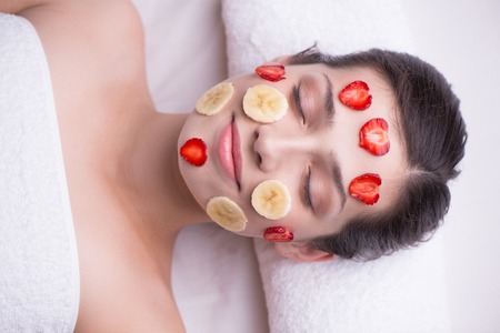 Relaxed young woman enjoying a beauty treatment in a health spa の写真素材
