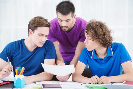 Education, campus and teenage concept - Students learning new information in classroom
