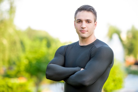 Portrait of a young sportsman standing in the parkの写真素材