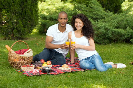 Portrait of a happy international couple spending time together in parkの写真素材