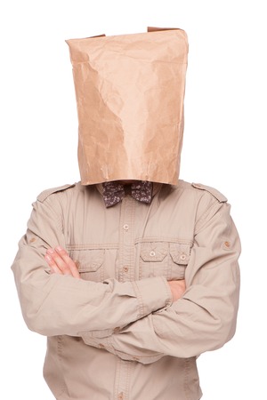 Young  businessman with paper packet on head and crossed arms, isolated on white backgroundの写真素材