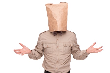 Young  businessman with paper packet on head and crossed arms, isolated on white backgroundの写真素材