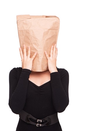 Young business woman with paper packet on head, isolated on whiteの写真素材