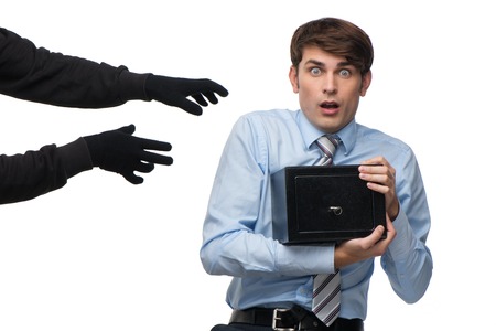 Theft trying to steal cashbox. Thievery money conceptの写真素材