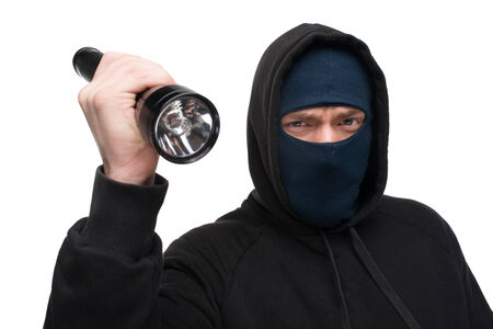Scary theft with flashlight looking at the camera. Theft concept