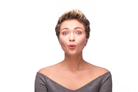 Close up portrait of beautiful surprised woman with copper-colored hairの写真素材