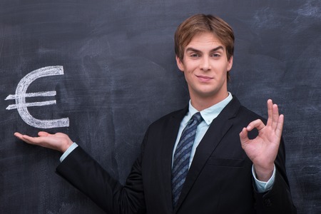 Male in bussines suit showing OK gestureの写真素材