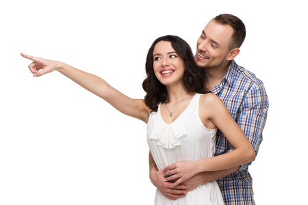 Woman points at something. Both lovers looking at something with interest. Isolated on white backgroundの写真素材