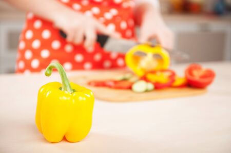 Close up photo of woman chopping paprika for salad. Concept for cooking in the kitchenの写真素材
