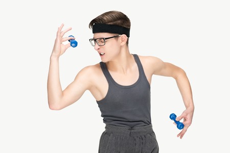 Funny sporty nerd in glasses and dumbbells isolated on white backgroundの写真素材