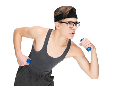 Funny sporty nerd in glasses and dumbbells isolated on white backgroundの写真素材