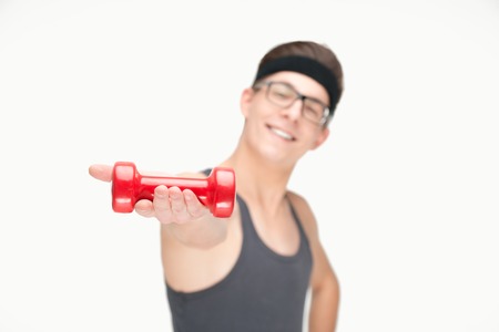Funny sporty nerd in glasses and dumbbells isolated on white backgroundの写真素材