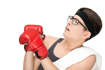 Funny sporty nerd in glasses and box gloves isolated on white backgroundの写真素材