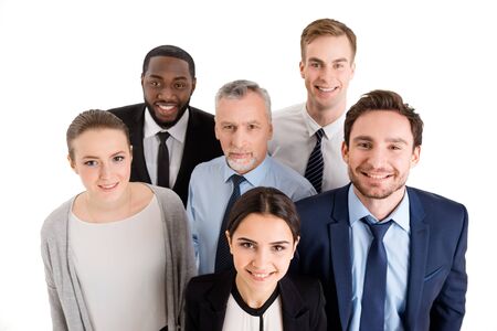 Multi-ethnic business team standing isolated on white, smiling and looking up to cameraの写真素材