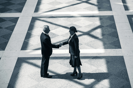 Top view photo of creative business people. Business people standing on marble floor and shaking hands while meetingの写真素材