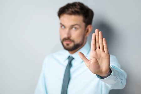 Close up photo of young attractive businessman. Unhappy businessman showing stop gestureの写真素材