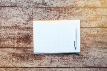 Creative horizontal top view photo of business objects on light colored woodblocks. There are...