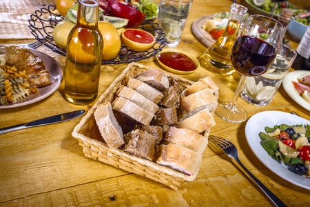 Close up creative photo of delicious meal on wooden vintage table. Focus on plate with breadの写真素材