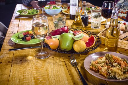 Close up creative photo of delicious meal on wooden vintage table. Focus on plate with fruitsの写真素材