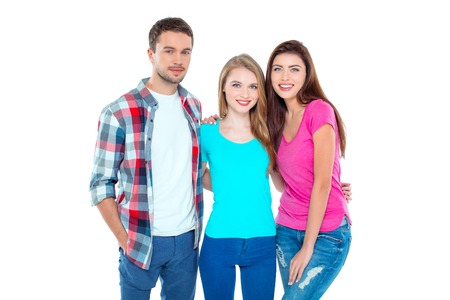 Studio shot of nice young friends. Beautiful people looking at camera and smiling. Isolated backgroundの写真素材