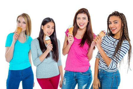 Studio shot of nice young friends. Beautiful girls looking at camera, holding ice-creams and smiling. Isolated backgroundの写真素材