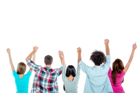 Studio shot of nice young multicultural friends. Beautiful people standing back and holding hands up. Isolated background. Free space for your logoの写真素材