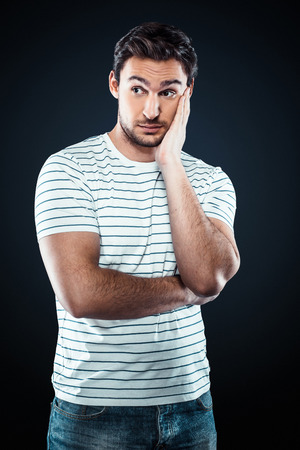 Studio shot of caucasian young businessman. Unhappy businessman looking asideの写真素材