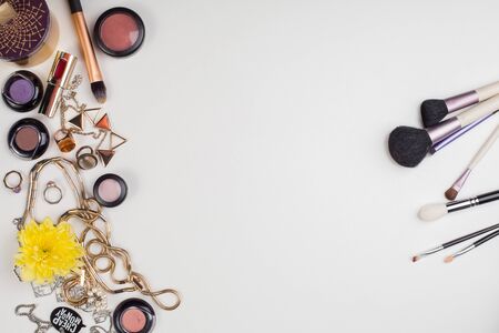 Women's accessories and cosmetics. Top view photo of colorful and glamour objects with free space for . There are makeup brushesの写真素材