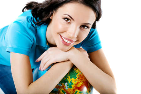 Travel concept. Portrait of stylish beautiful young woman isolated on white background. Woman smiling, looking at camera and holding globeの写真素材