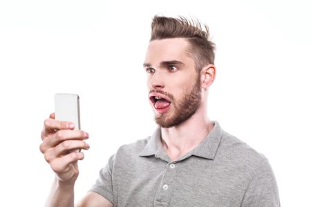 Funny concept for man with windblown mouth. Man using mobile phone. Isolated on white backgroundの写真素材
