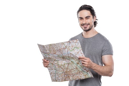 Portrait of stylish handsome young man isolated on white background. Man smiling and holding mapの写真素材