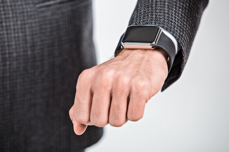 Close up photo of stylish handsome young man isolated on white background. Man with smart watchの写真素材