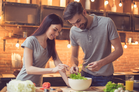 Young couple cooking in kitchenの写真素材