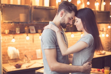 Young couple cooking in kitchenの写真素材
