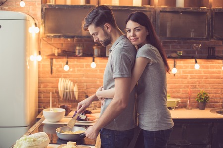 Young couple cooking in kitchenの写真素材