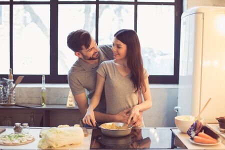 Young couple cooking in kitchenの写真素材