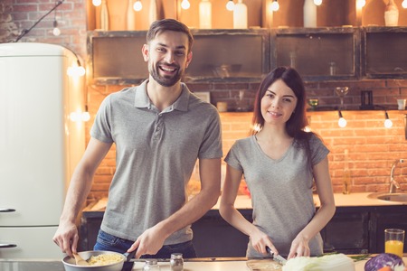 Young couple cooking in kitchenの写真素材