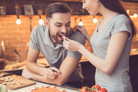 Young couple cooking in kitchenの写真素材