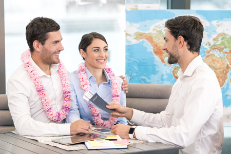 Young Man Travel Agent with Clients Conceptの写真素材