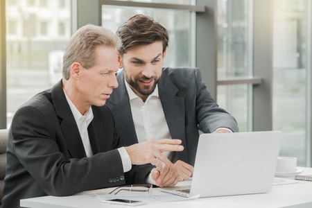 Stylish businessmen working in officeの写真素材