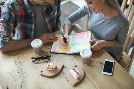 Nice looking man and woman in cafeの写真素材