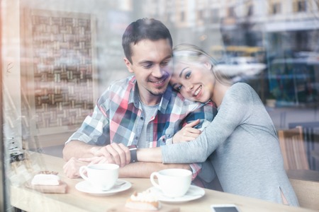 Nice looking man and woman in cafeの写真素材
