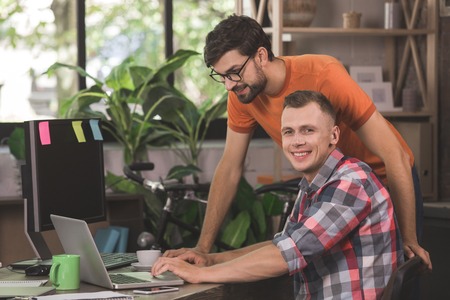 Young men programmers working together in the officeの写真素材