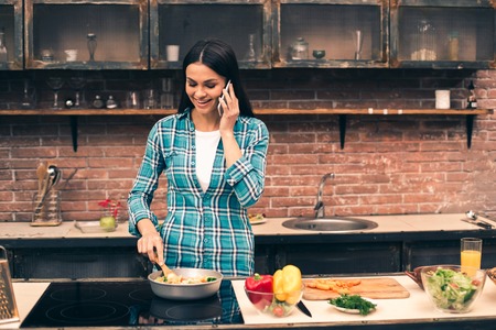 Young woman cooking on kitchenの写真素材
