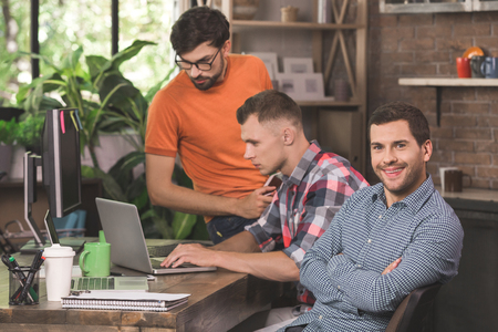 Young men programmers working together in the officeの写真素材
