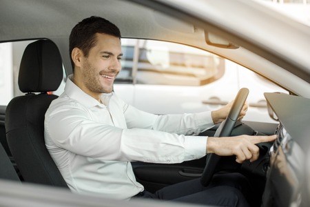 Young Man in a Car Rental Service Test Drive Concept