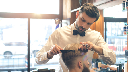 Young Man in Barbershop Hair Care Service Conceptの写真素材