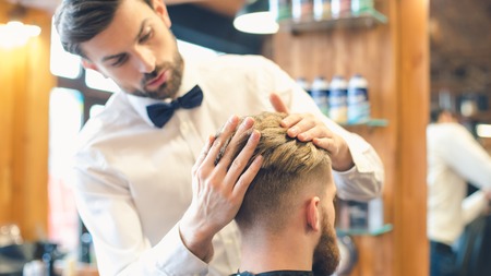 Young Man in Barbershop Hair Care Service Conceptの写真素材